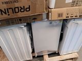 many boxes of white appliances stacked on top of each other
