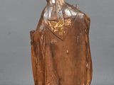 statue of a man with a hat and robe on a gray surface