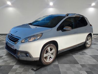 the small white car is parked in a room with a checkered floor