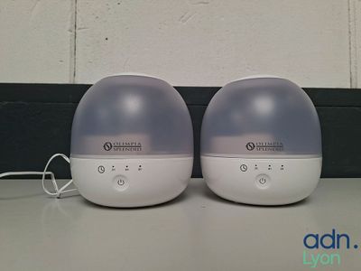 two air humiders sitting on a table next to each other