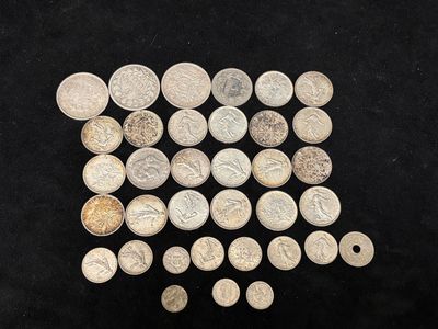 a pile of silver coins sitting on top of a black surface