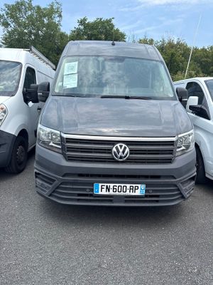 three vans parked in a parking lot next to each other