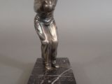 a statue of a man holding a baseball bat on a marble base