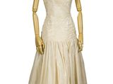 a mannequin dress on display on a wooden stand