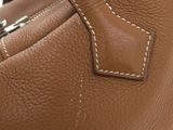 leather handbag with white stitching on the inside of it