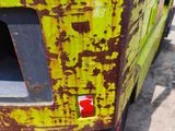 a yellow truck with rust on the side of it