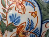 a close up of a vase with a flower design on it