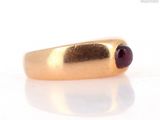 an image of a gold ring with a garnett on it
