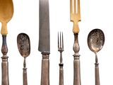 five forks, a knife, and a spoon on a white background