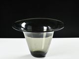 a black and white vase sitting on a white table