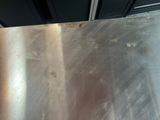 a metal table that has a metal surface on it