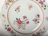a plate with a floral design on it sitting on a table