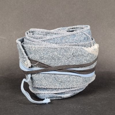 a stack of cloth wrapped around a string on top of a table
