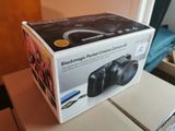a black camera sitting on top of a box on a table