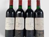 three bottles of wine are lined up on a white surface