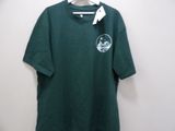 a green shirt hanging on a hanger on a wall