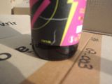 a bottle of soda sitting on top of a cardboard box