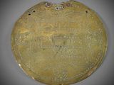 a gold plate with a design on the front of it