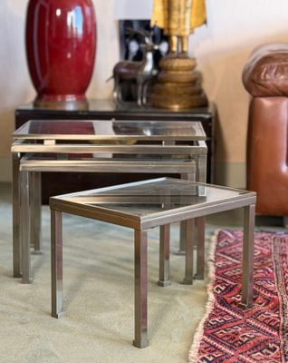 three tables that are sitting on a rug in a room