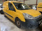 La camionnette jaune est garée dans un garage avec d'autres véhicules.