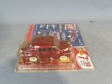 a red toy car sitting on top of a magazine