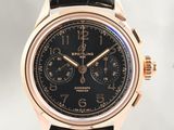 a close up of a watch with a black dial