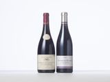 two bottles of wine sitting next to each other on a table