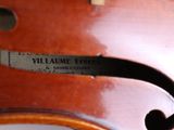 the back of a violin with a label on the back of it