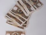 a pile of money sitting on top of a white table