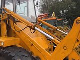 a large yellow tractor that is parked in a lot
