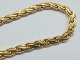 a gold chain bracelet with a clasp on a white surface
