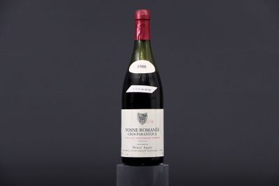 a bottle of wine sitting on top of a black table