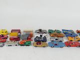 a lot of toy cars and trucks on a white surface