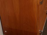 a wooden cabinet and a wooden bench in a room