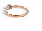 a close up of a gold ring on a white surface