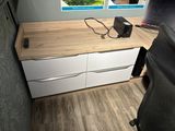 a desk with a chair and a computer on it
