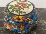 a colorful box with flowers on it sitting on a table