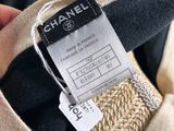chanel label on a black and beige sweater