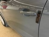 a close up of a car door handle with a sticker on it