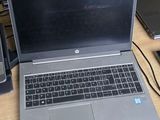 a laptop computer sitting on top of a wooden desk