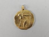 a close up of a gold coin with a man on it