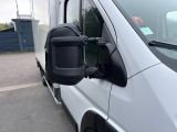 a white van parked in a parking lot with its door open