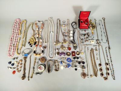 many different types of necklaces and bracelets laid out on a table