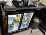 a kitchen with a refrigerator, sink, and counter top