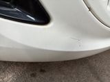 a close up of a car ' s front bumper with scratches on it