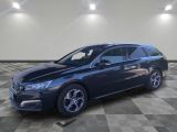 a picture of a blue car parked in a garage
