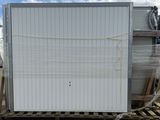 a white refrigerator sitting on a pallet in the middle of a yard