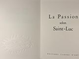 a close up of an open book with a picture of a sun on it