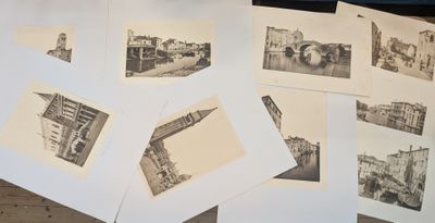 several black and white photos of a bunch of buildings on a table