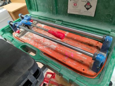 a green case with a bunch of tools inside of it